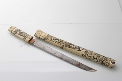 Lot 702 - Late 19th Japanese tanto dagger in ornately carved bone scabbard with Figural decoration, blade 27cm in length