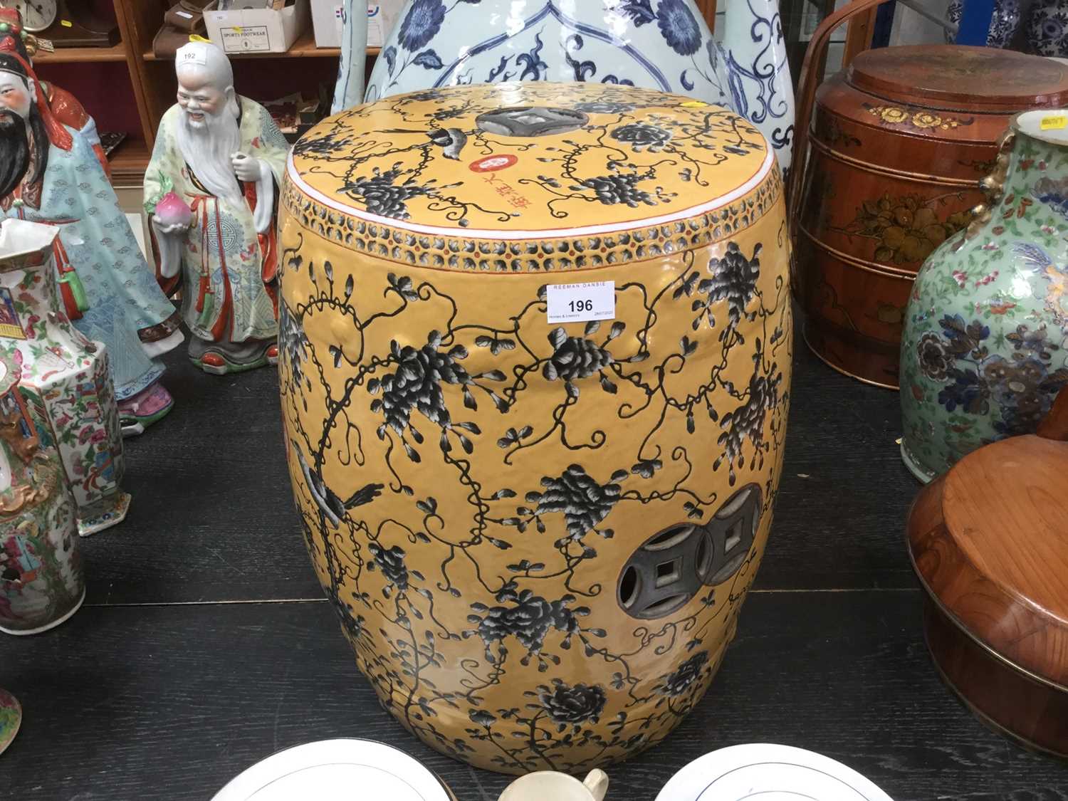 Lot 196 - Chinese porcelain garden seat of barrel shape, decorated with birds and trailing foliage on yellow ground. 48cm high, diameter 34cm