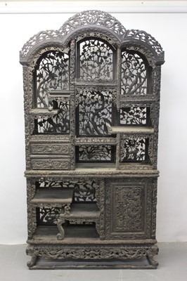 Lot 1235 - Late 19th century Chinese carved hardwood two height open display cabinet