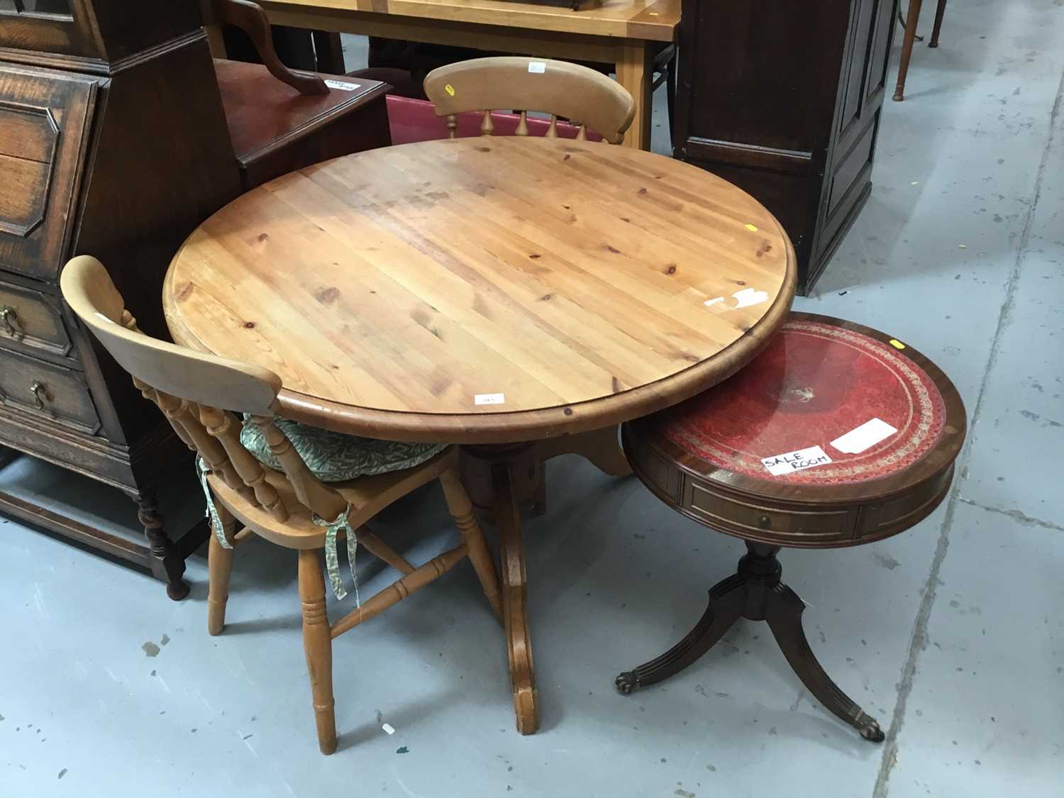 Lot 865 - Pine circular breakfast table on tripod base  and two pine kitchen chairs