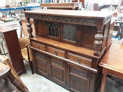 Lot 910 - Old Charm carved oak court cupboard with leaded glazed doors above, three drawers and three doors below with linen fold decoration