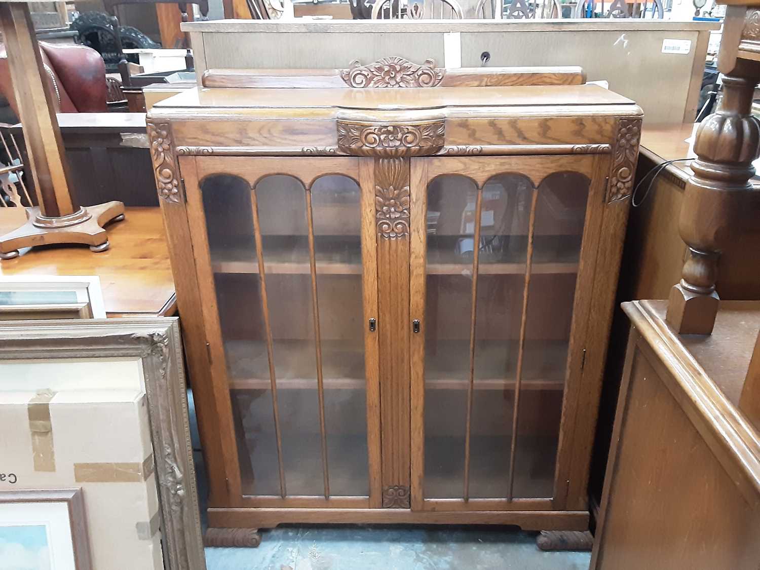 Lot 930 - 1930's carved oak china display cabinet with glazed doors