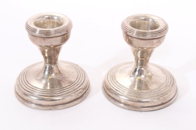 Lot 310 - Pair 1940s silver candlesticks with tapering stems and circular pedestal bases (Birmingham 1949) Henry Clifford Davis. Together with a pair contemporary silver dwarf candlesticks (Birmingham 1977)....