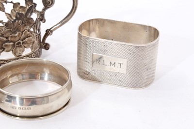 Lot 311 - Eight assorted silver napkin rings, together with a pair of silver cup holders (Various dates and makers) All at approximately 6ozs. (10)