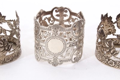 Lot 311 - Eight assorted silver napkin rings, together with a pair of silver cup holders (Various dates and makers) All at approximately 6ozs. (10)