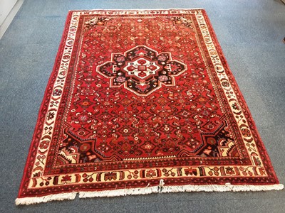 Lot 1406 - Eastern rug with geometric decoration on red, blue and cream ground 205cm x 152cm