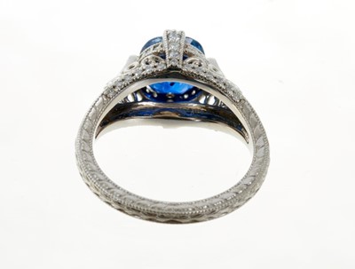 Lot 487 - A fine sapphire single stone ring with a natural cushion cut blue sapphire weighing 2.66ct in four claw setting with pavé set diamonds to the claws and bezel, pierced decoration on engraved shank....