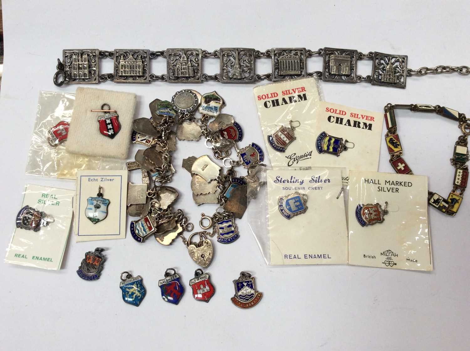 Lot 697 - Silver souvenir charm bracelet with silver enamelled charms, loose charms and two other souvenir bracelets