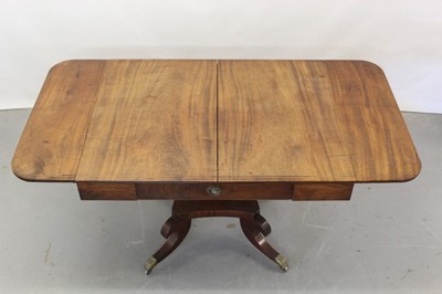 Lot 1265 - George III inlaid mahogany sofa table with frieze drawer, two flaps, square taper column on shaped platform with four scroll legs on brass castors, opening to 146 x 73 cm, 72cm high