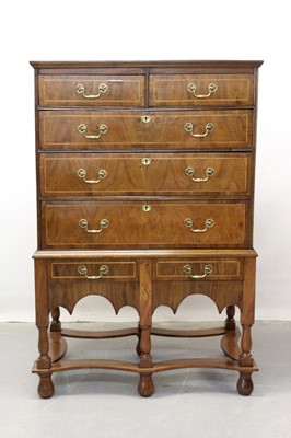 Lot 1289 - 18th century and later walnut chest on stand with two short and three long graduated drawers and two drawers below with brass handles, crossbanded and feather strung decoration on turned legs joine...