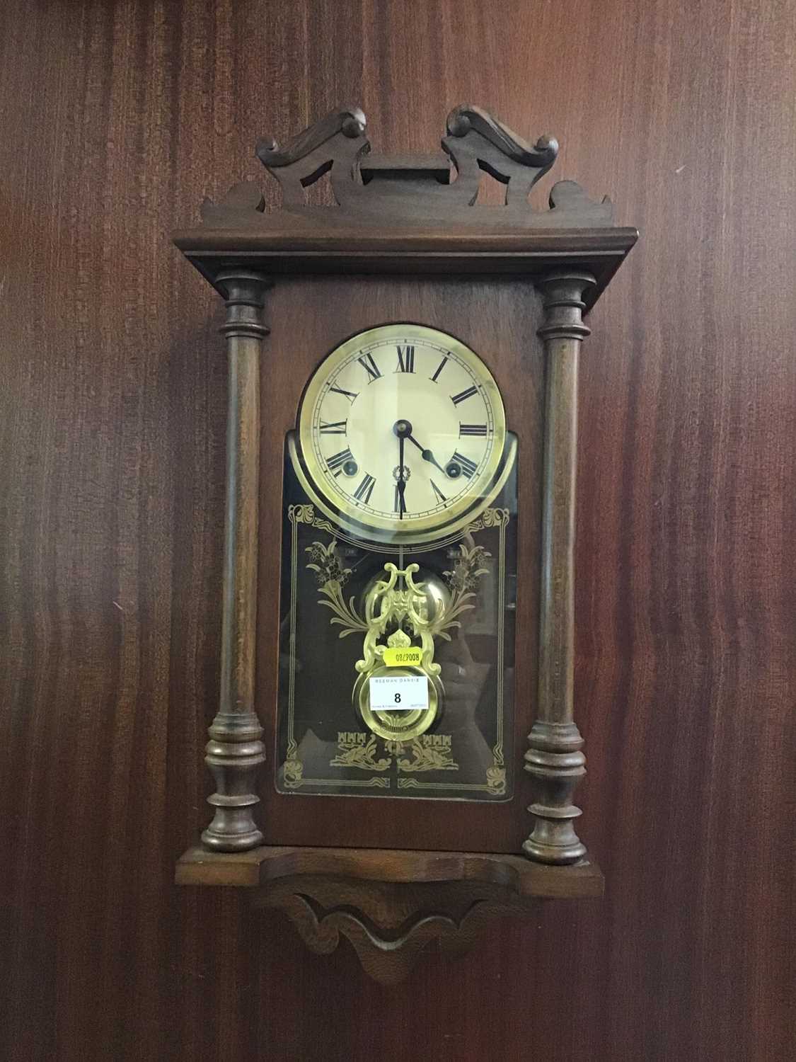 Lot 8 - Oak hanging wall clock enclosed by glass frame with pendulum