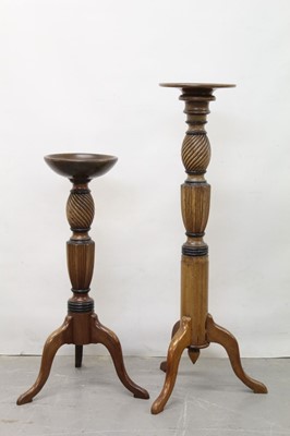 Lot 1298 - Two 19th century mahogany torchères converted from bedposts on tripod bases