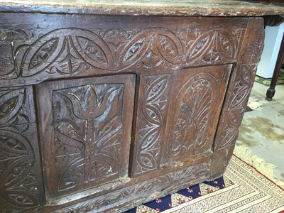 Lot 1300 - Large 17th century carved oak coffer with tulip decoration