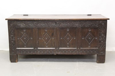 Lot 1345 - 17th century carved oak coffer, with later hinged top and four lozenge panel front between scroll carved muntins on stiles, 143cm wide x 54cm deep x 66cm high