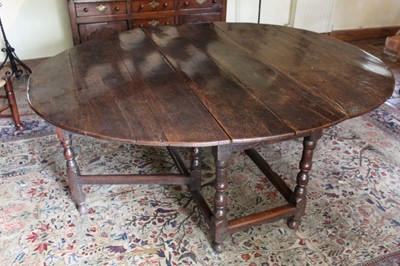 Lot 1311 - Late 17th century oak oval gateleg dining table of good patination, the elliptical hinged top on turned and block understructure, end drawer, 153cm x 178cm