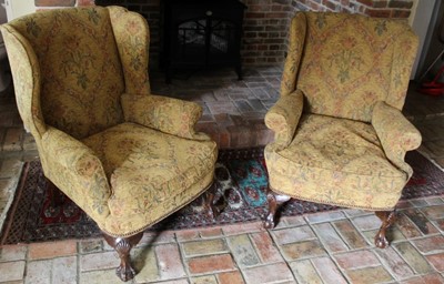 Lot 1312 - Pair of George I style wing armchairs, floral upholstered on shell-capped cabriole legs with claw and ball feet.