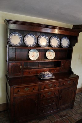 Lot 1313 - Early 18th century oak high dresser, the plate rack with an arrangement of drawers and cupboards, with conforming base, 149cm wide.