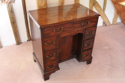 Lot 1328 - George III mahogany kneehole dressing table with seven drawers and concelaed apron drawer about the cupboard kneehole, on bracket feet, 75cm.