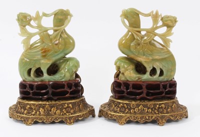 Lot 640 - Pair of jade carvings on stands