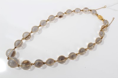 Lot 505 - Antique crystal bead necklace with 23 graduated spherical beads cased in gold wire cages on a gold clasp, 46cm