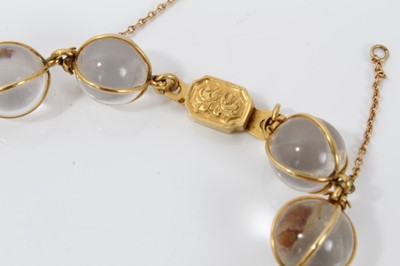 Lot 505 - Antique crystal bead necklace with 23 graduated spherical beads cased in gold wire cages on a gold clasp, 46cm