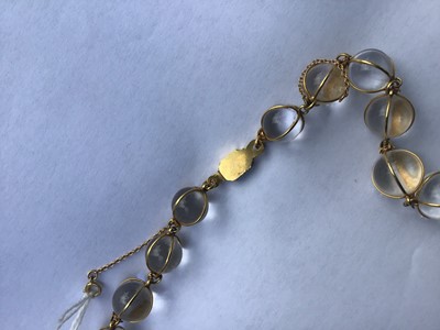 Lot 505 - Antique crystal bead necklace with 23 graduated spherical beads cased in gold wire cages on a gold clasp, 46cm