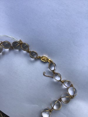Lot 505 - Antique crystal bead necklace with 23 graduated spherical beads cased in gold wire cages on a gold clasp, 46cm