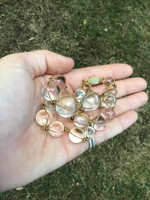 Lot 505 - Antique crystal bead necklace with 23 graduated spherical beads cased in gold wire cages on a gold clasp, 46cm