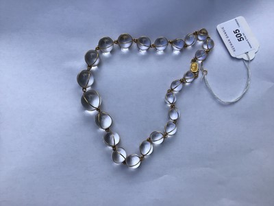 Lot 505 - Antique crystal bead necklace with 23 graduated spherical beads cased in gold wire cages on a gold clasp, 46cm
