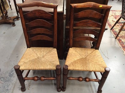 Lot 1385 - Set of six early 19th century Lancashire ash and elm ladder back dining chairs with rush seats on turned legs and stretchers