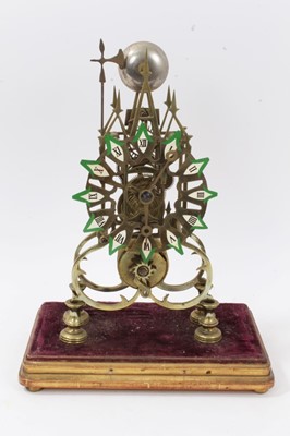 Lot 602 - Victorian brass gothic skeleton clock with single fusee movement striking on bell on giltwood and velvet base, key and pendulum present 37cm high