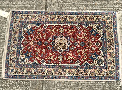 Lot 1410 - Persian style part silk rug, with claret red ground and arabesque ornament.120 x 73cm