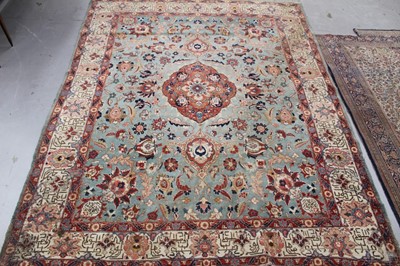 Lot 1418 - Antique Heriz style carpet, with central medallion and meandering lotus flower ornament on duck egg blue ground, within conforming broad border, with Islamic script, 360 x 290cm