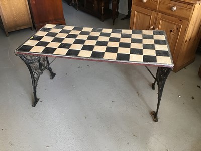 Lot 71 - Cast iron garden table with chequered tiled top