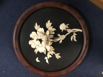 Lot 176 - Japanese carved bone and lacquered circular plaque, in high relief with Chrysanthemum and butterfly