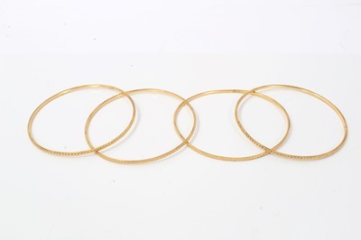 Lot 207 - Four Eastern gold bangles