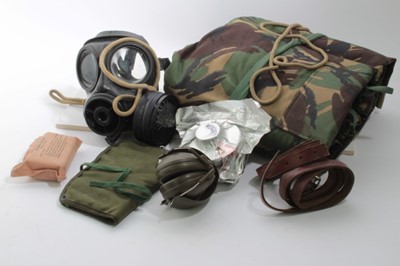 Lot 666 - One box of British Army uniform and equipment circa 1970s to include Gas mask, ear defenders and other items