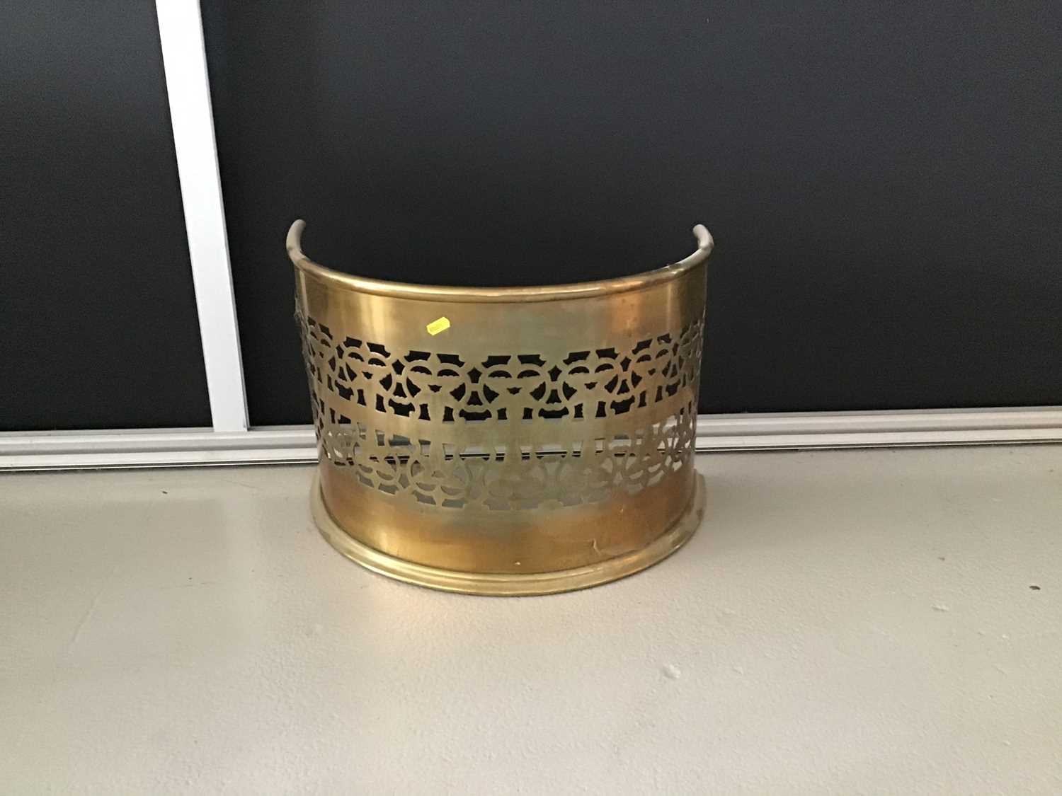 Lot 3 - Narrow antique brass fender of bowed form with pierced decoration H36cm W53cm D30cm