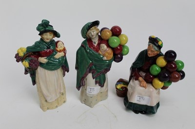 Lot 871 - Three Royal Doulton figures - The Balloon Seller HN583, The Flower Seller HN989 and The Old Balloon Seller HN1315