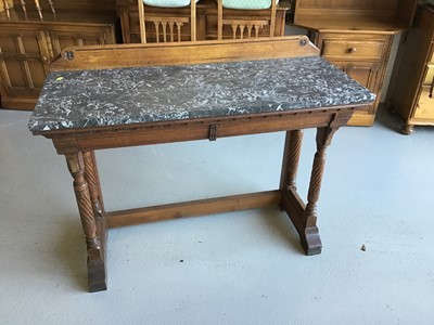 Lot 47 - Victorian oak marble topped tall table with ledge back two drawers below on carved supports H83cm W114cm D47cm
