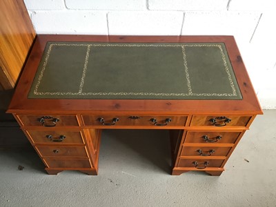 Lot 51 - Reproduction yew wood twin pedestal desk with green leather top and an arrangement of eight drawers below on bracket feet together with a similar desk chair