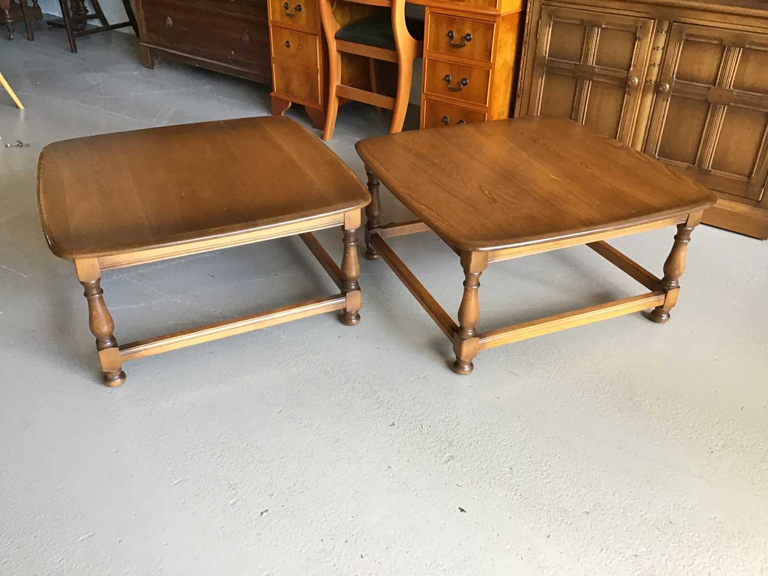Lot 61 - Pair of Ercol elm coffee tables on turned legs joined by stretcher H38.5cm W75cm D75cm