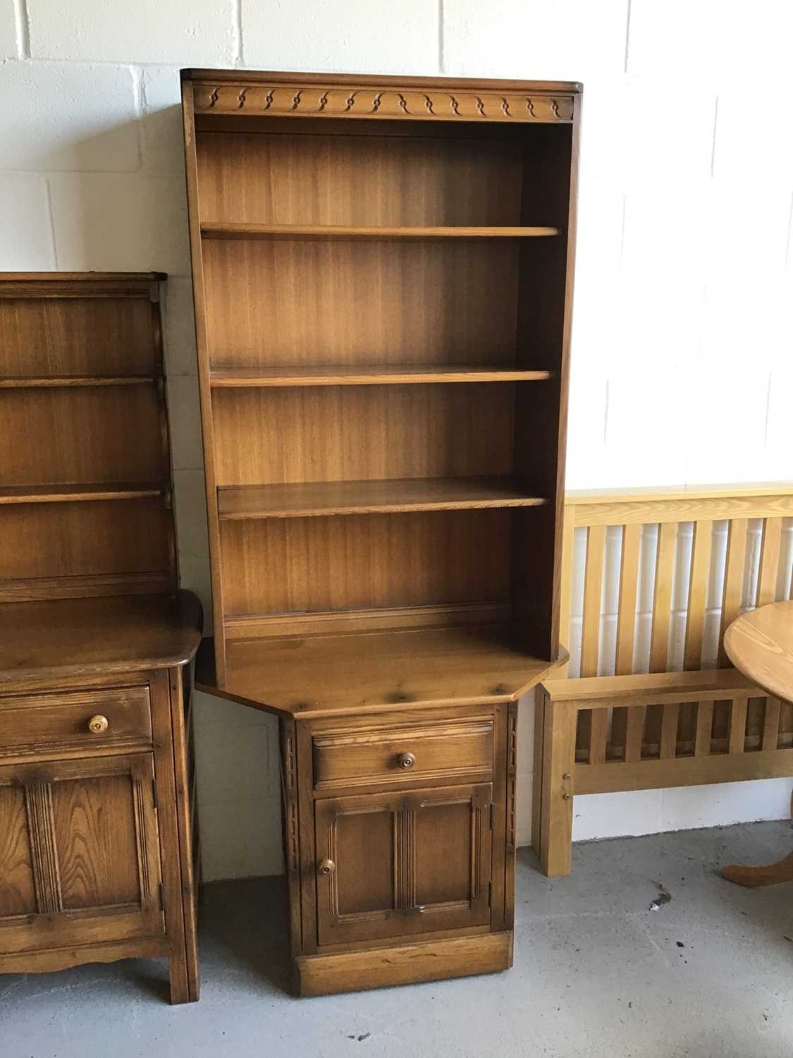 Lot 32 - Ercol elm two height bookcase with three opened shelves above single drawer and cupboard below H196.5cm W80cm D50cm