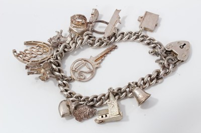 Lot 85 - Silver charm bracelet with thirteen charms