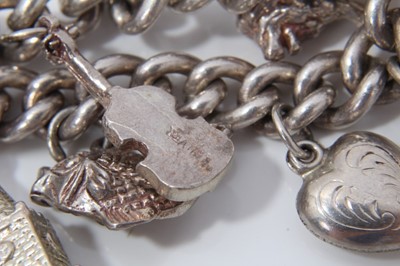 Lot 85 - Silver charm bracelet with thirteen charms