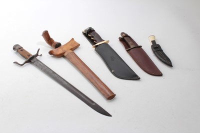 Lot 752 - Second World War Japanese Arisaka type 30 bayonet, with an unusual quillion (lacking scabbard), together with two hunting knives, a Malayan Kris and a miniature Kukri. (5)