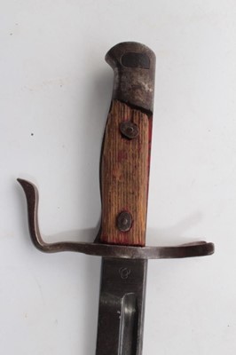 Lot 752 - Second World War Japanese Arisaka type 30 bayonet, with an unusual quillion (lacking scabbard), together with two hunting knives, a Malayan Kris and a miniature Kukri. (5)