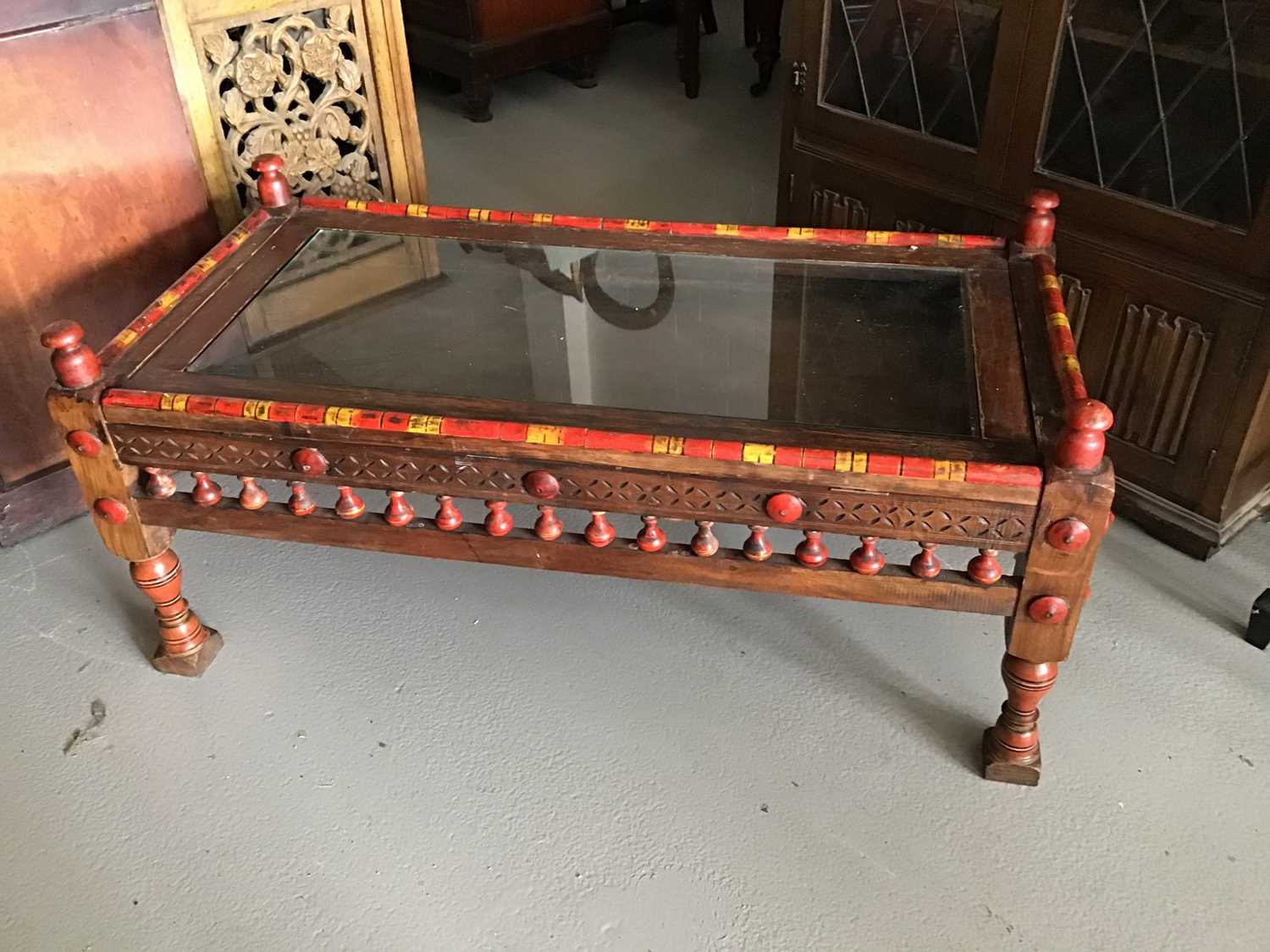 Lot 84 - 20th century Pakistani coffee/display table with carved, turned and painted decoration H56.5cm W123cm D60.5cm