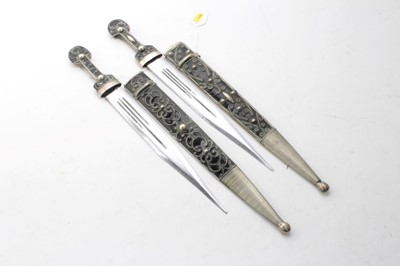 Lot 764 - Two Balkan decorative  white metal mounted daggers