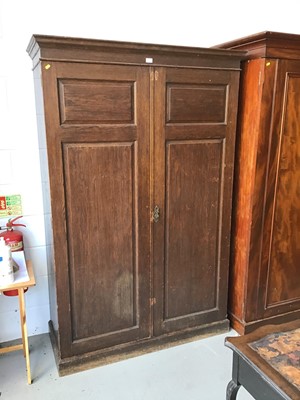 Lot 123 - Antique oak wardrobe with two panelled doors enclosing four sliding drawers two short and two long drawers on plinth base